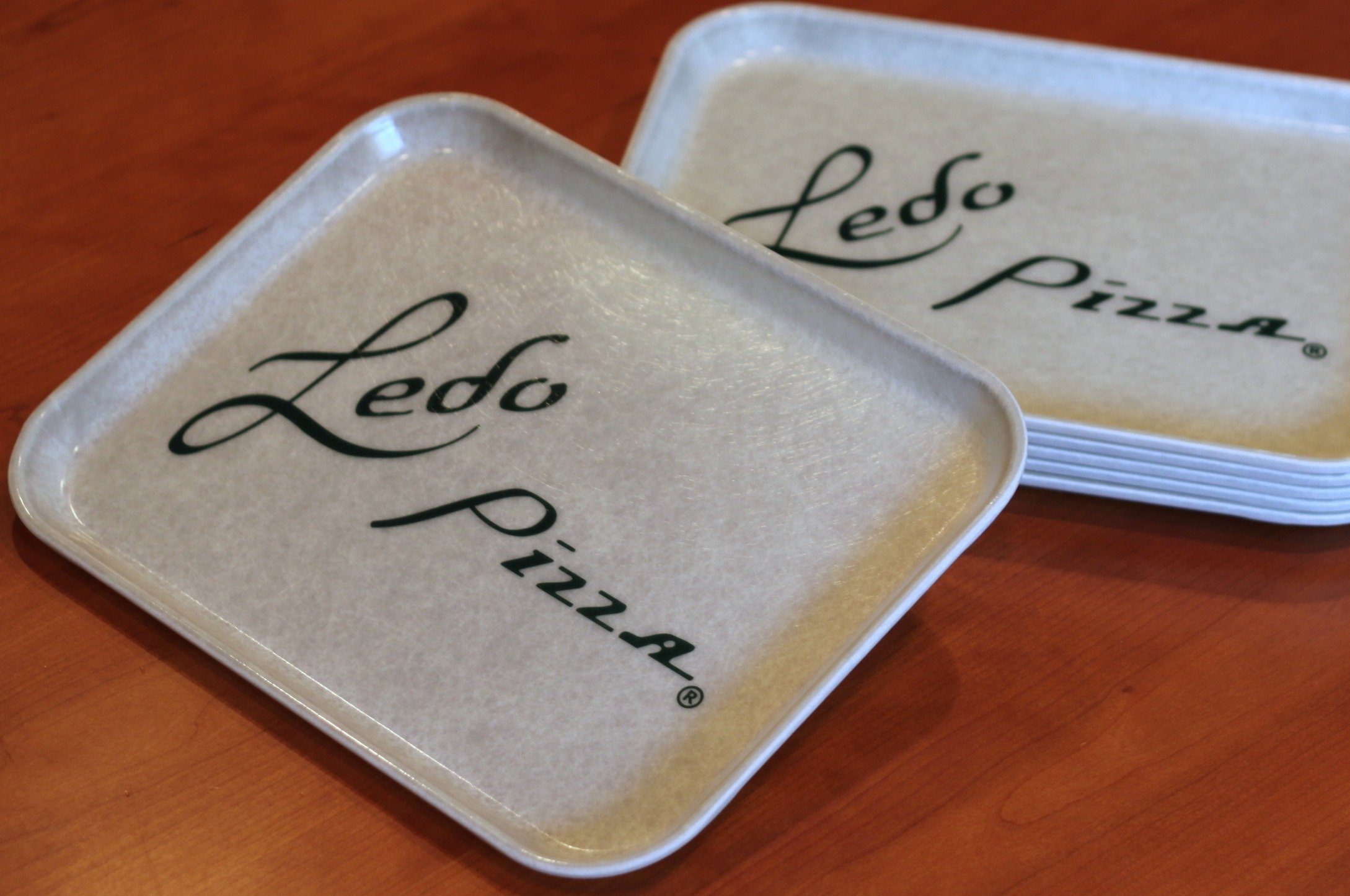 Photo of a few Ledo Pizza Trays on a table
