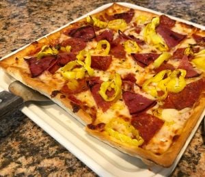 Why is Ledo Pizza's crust so flaky?