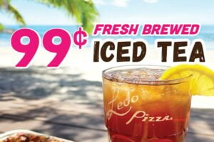 Picture of Iced tea with a beach background. Fresh Brewed 99 cent iced tea label on image.