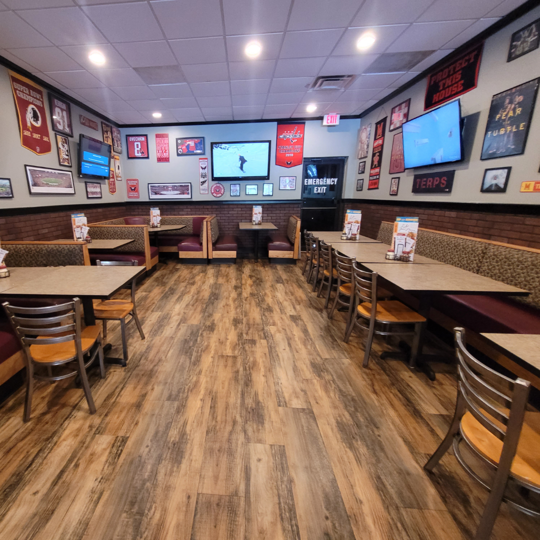 Room to Celebrate Party room at Ledo Pizza Crofton with tables, booth seating, TVs, and sports memorabilia