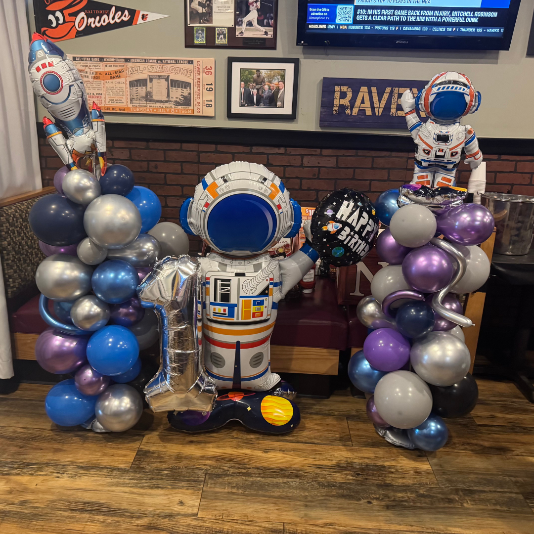 Make It Your Own Space-themed birthday balloon display in the party room at Ledo Pizza Crofton